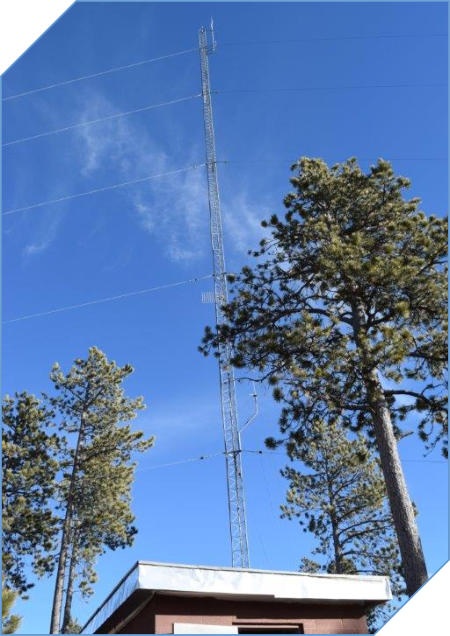 Image of a radio tower at a mountain top
                          repeater site